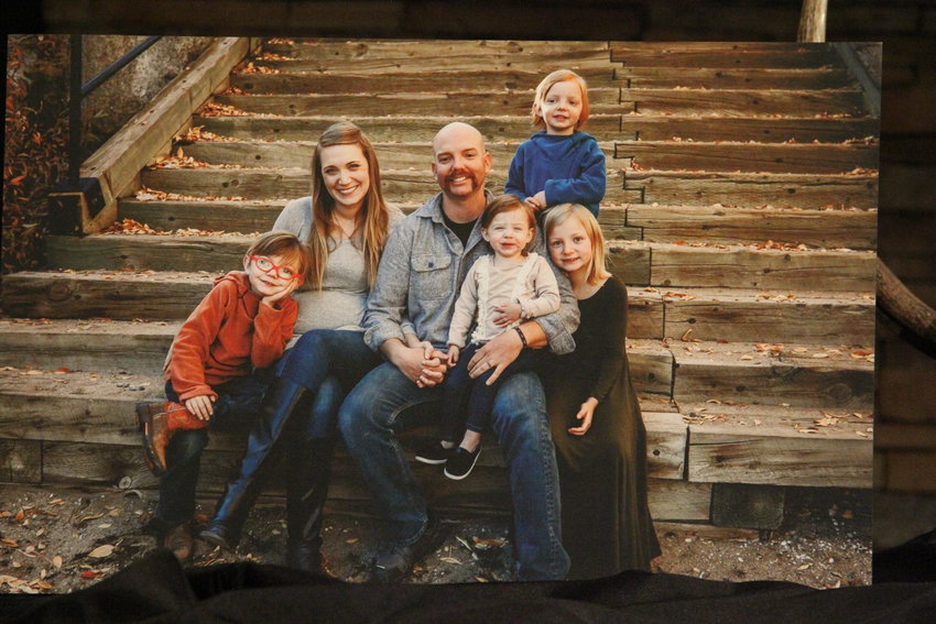 Cody Mooney with his wife, Emily Mooney, and their four children, in a photo that sat on the stage March 8 at a memorial service for Cody Mooney at Mission Hills Church in Littleton.